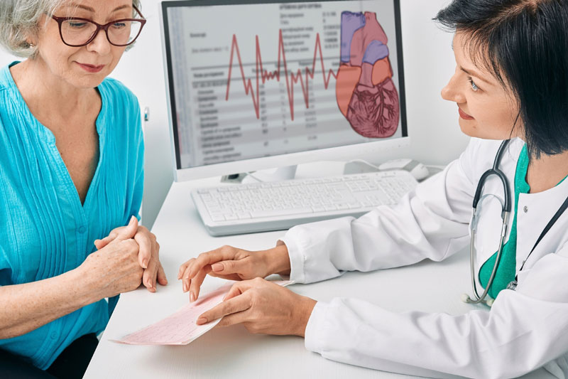 Cardiologist with patient reviewing a cardiac treatment plan.