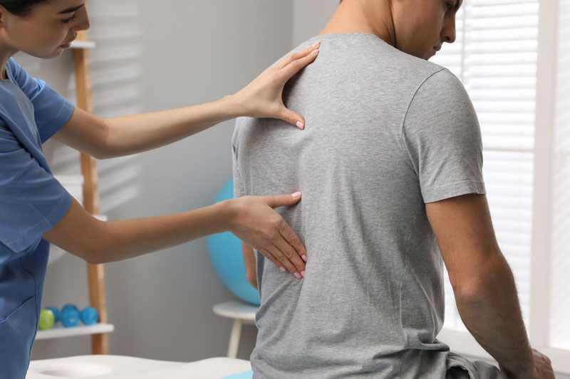 An interventional spine and pain specialist performs a treatment for her patient’s spine pain.